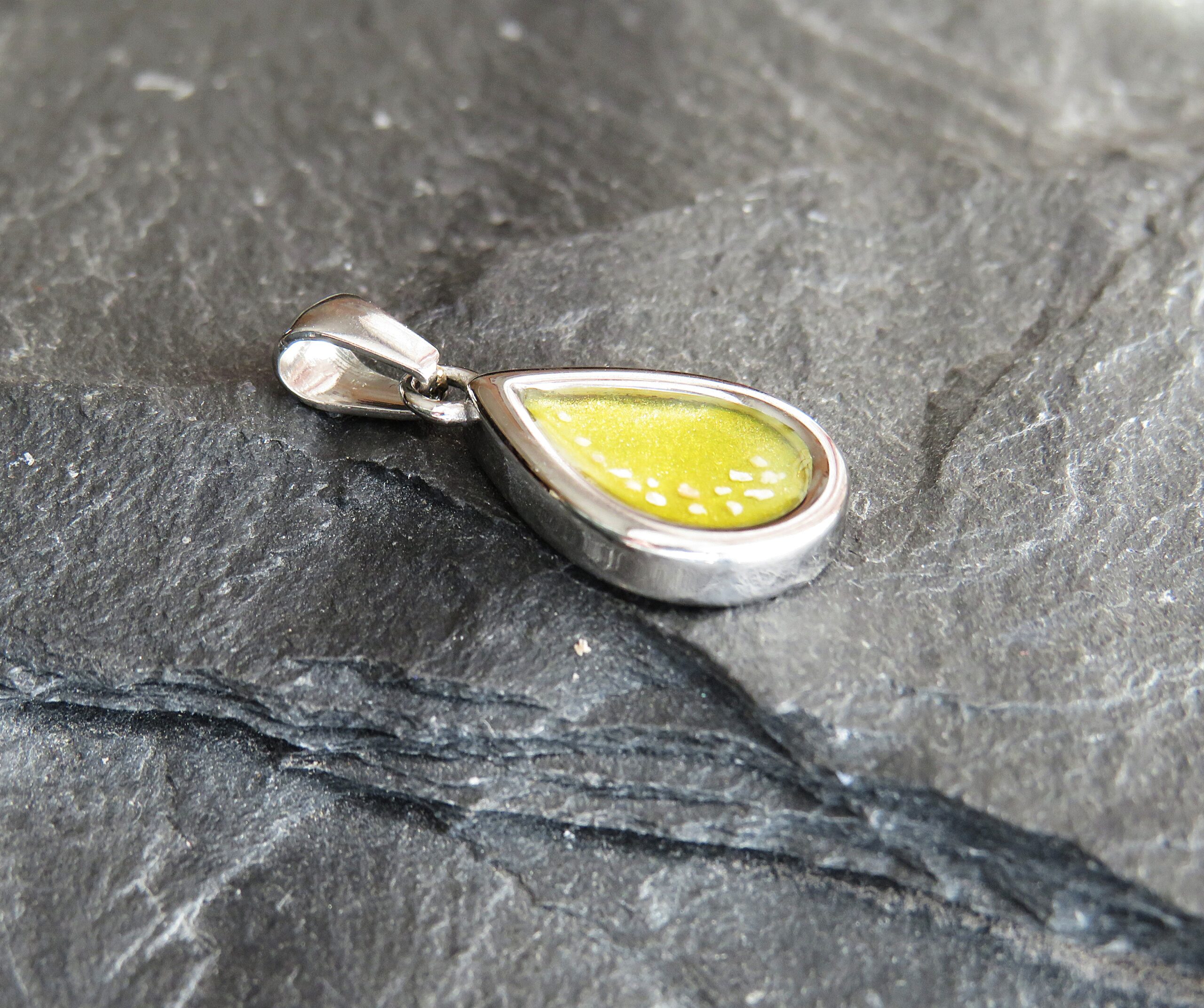 stainless steel mini tear drop ashes in resin pendant with yellow resin stainless steel mini tear drop ashes in resin pendant with yellow resin