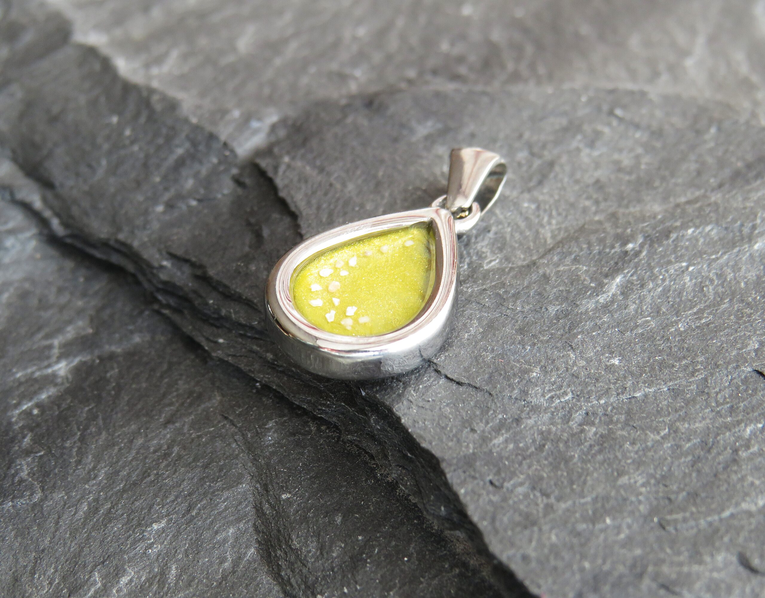 stainless steel mini tear drop ashes in resin pendant with yellow resin stainless steel mini tear drop ashes in resin pendant with yellow resin