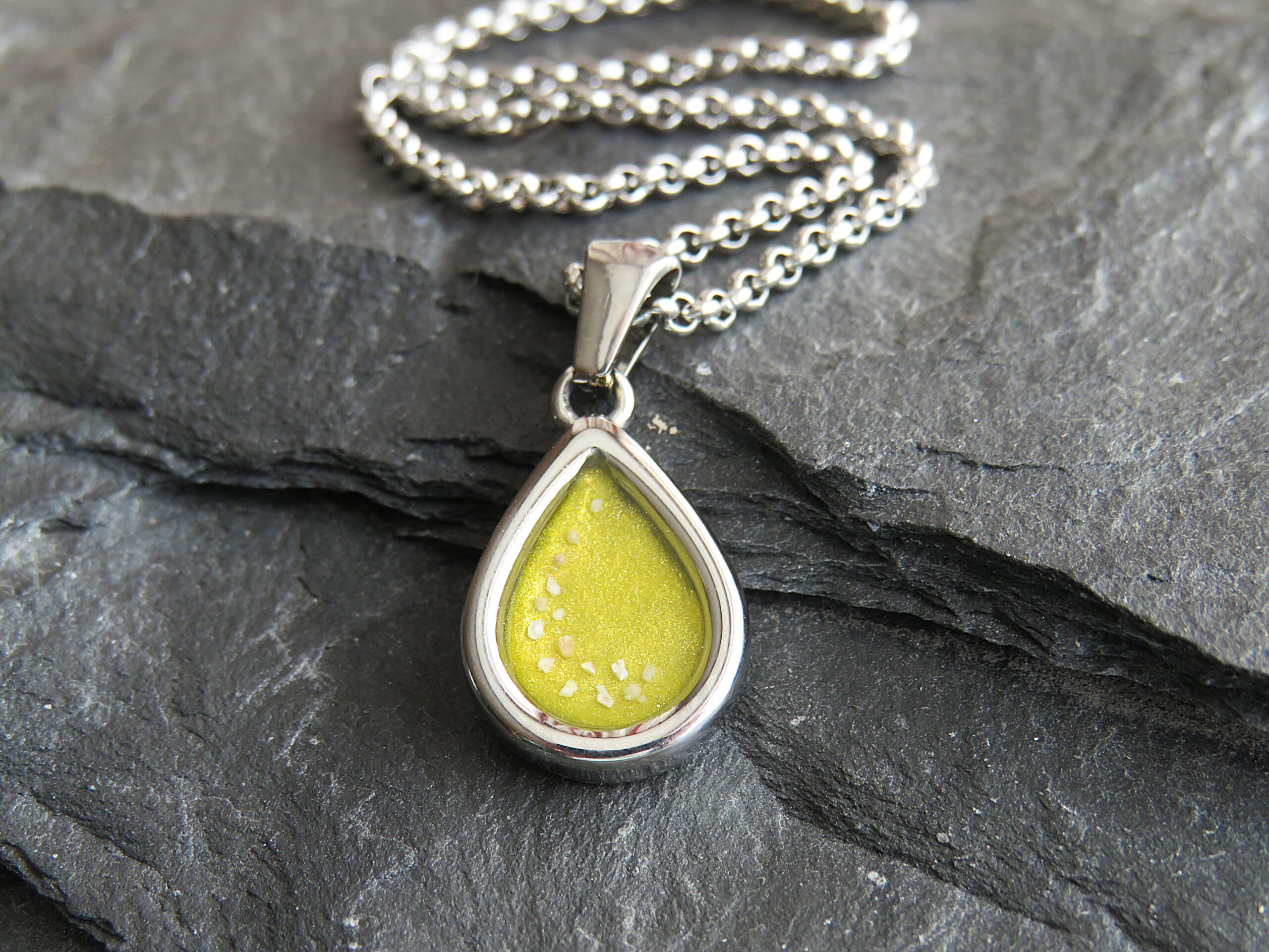 stainless steel mini tear drop ashes in resin pendant with yellow resin stainless steel mini tear drop ashes in resin pendant with yellow resin