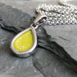 stainless steel mini tear drop ashes in resin pendant with yellow resin